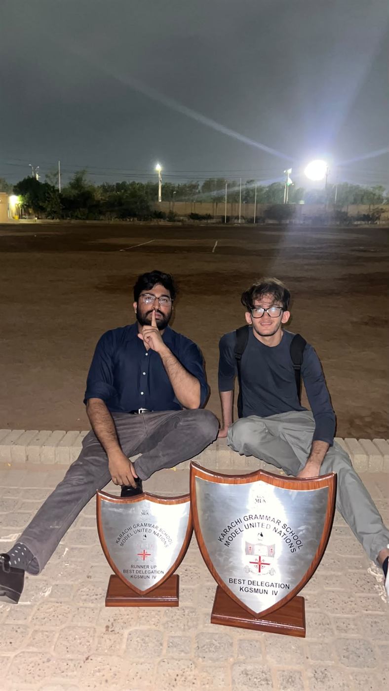 Ammar Hashmi and Rohaan Arshad laughing together away from a conference floor.