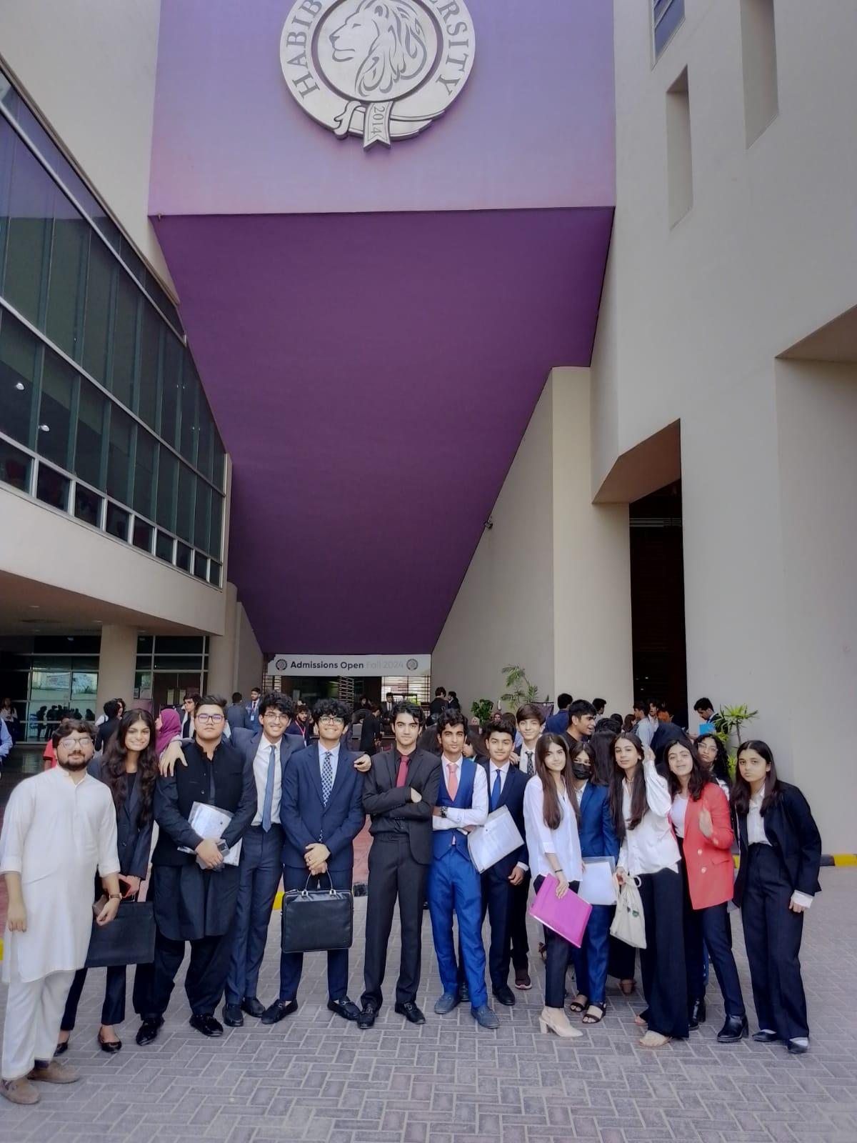 An MUN Society Pakistan delegation photographed outside Habib University before a conference.