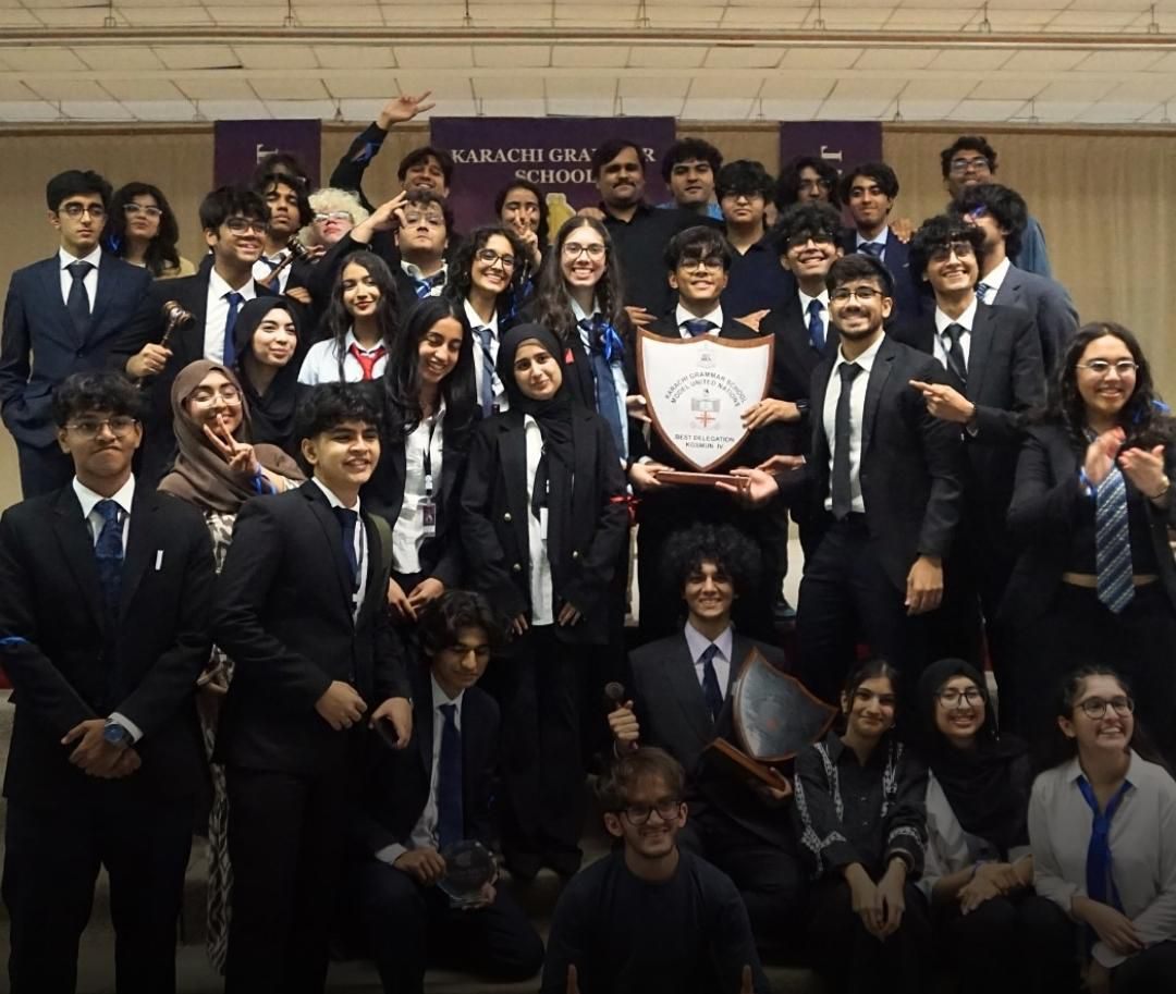 A delegation holding the Best Delegation shield at Karachi Grammar School Model United Nations.